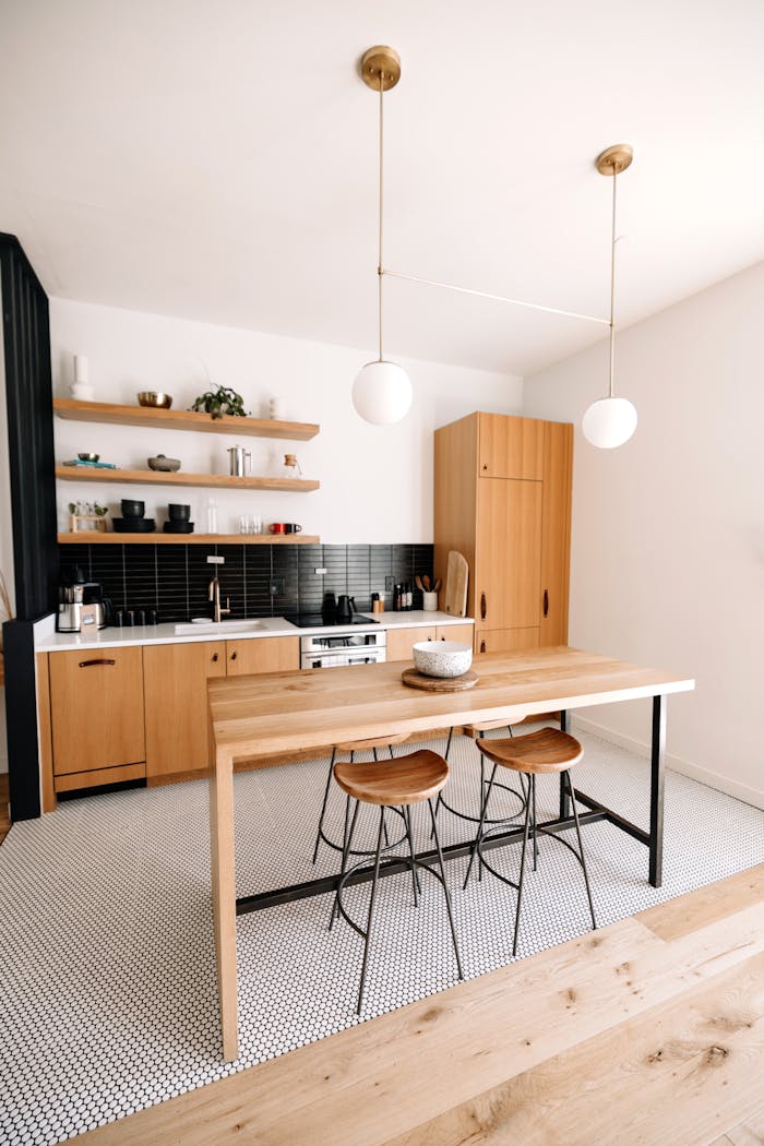 gallery-6 Bright minimalist kitchen with wooden furnishings and modern decor.