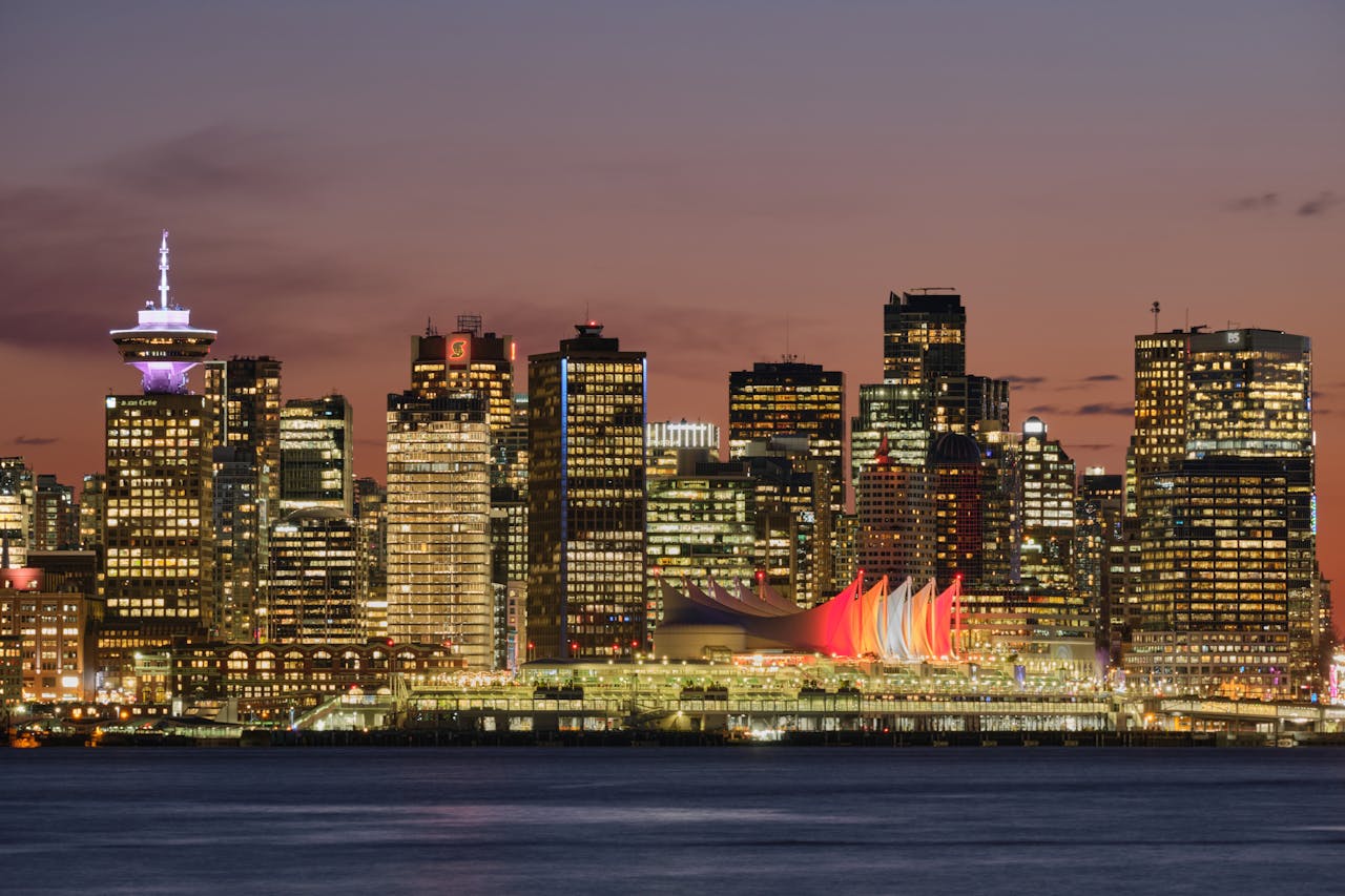 why-choose-us Stunning twilight view of Vancouver's illuminated downtown skyline and waterfront.