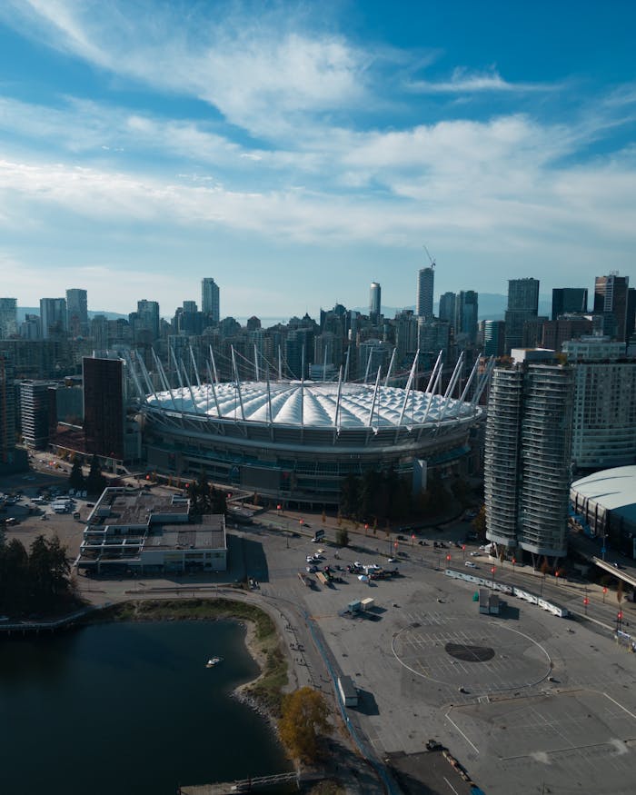 gallery-2 A stunning aerial view of BC Place amidst Vancouver's modern cityscape, showcasing urban architecture.